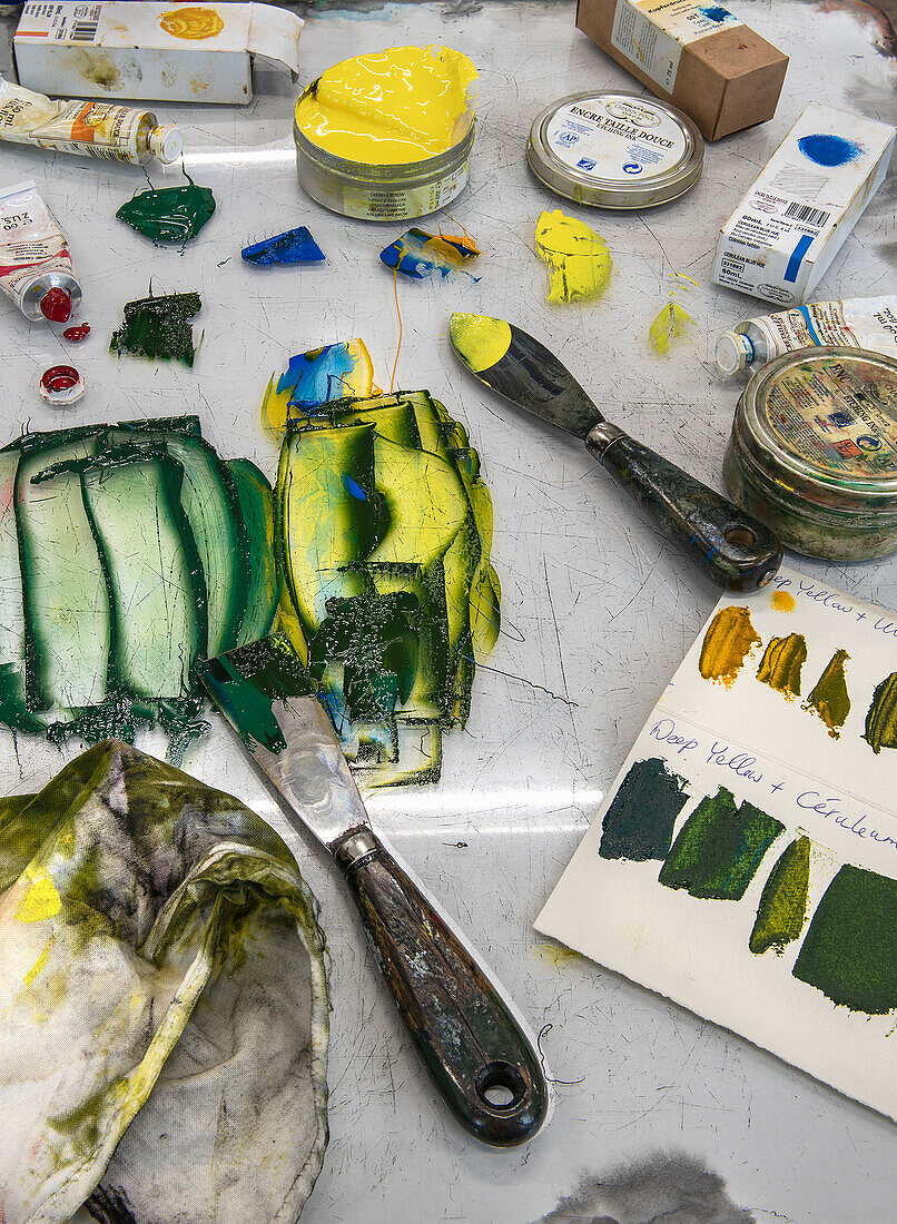 Work surface with painting utensils and color mixes