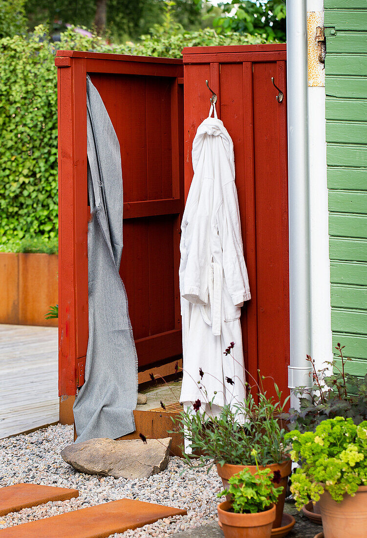 Changing room with hanging bathrobe in the garden area