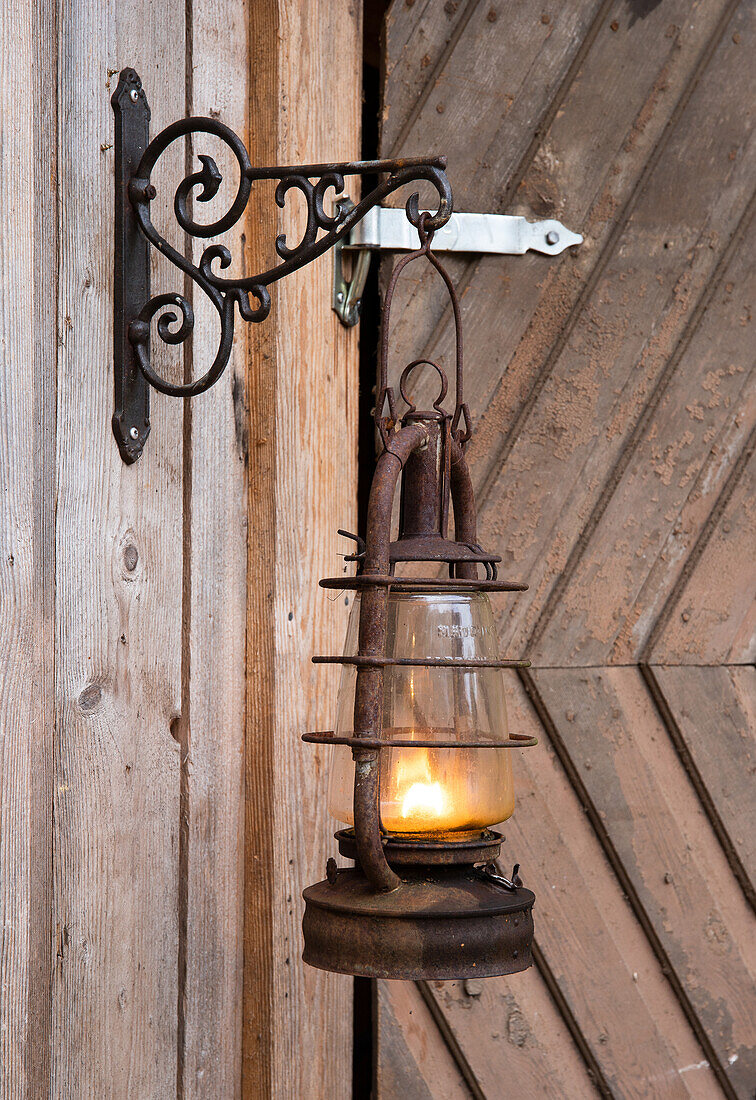 Rustic hanging lantern on wooden wall