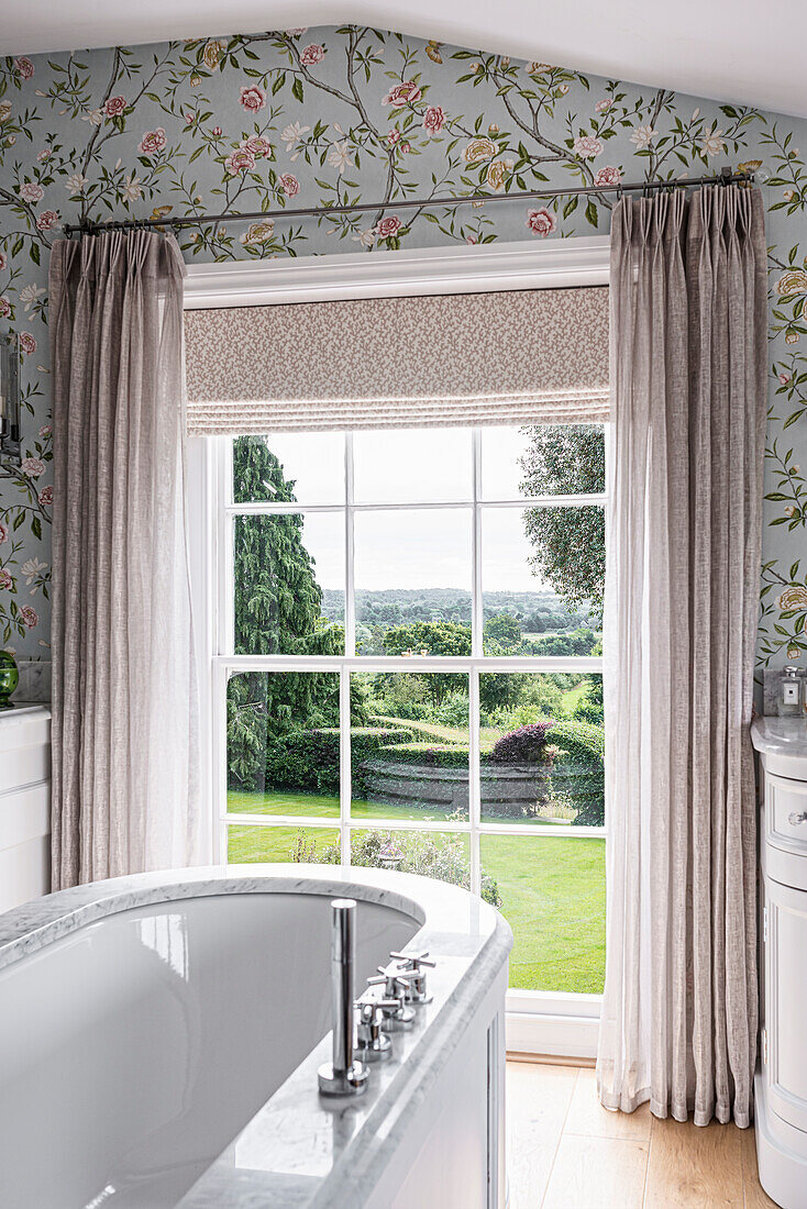 Bathroom with floral wallpaper and garden view