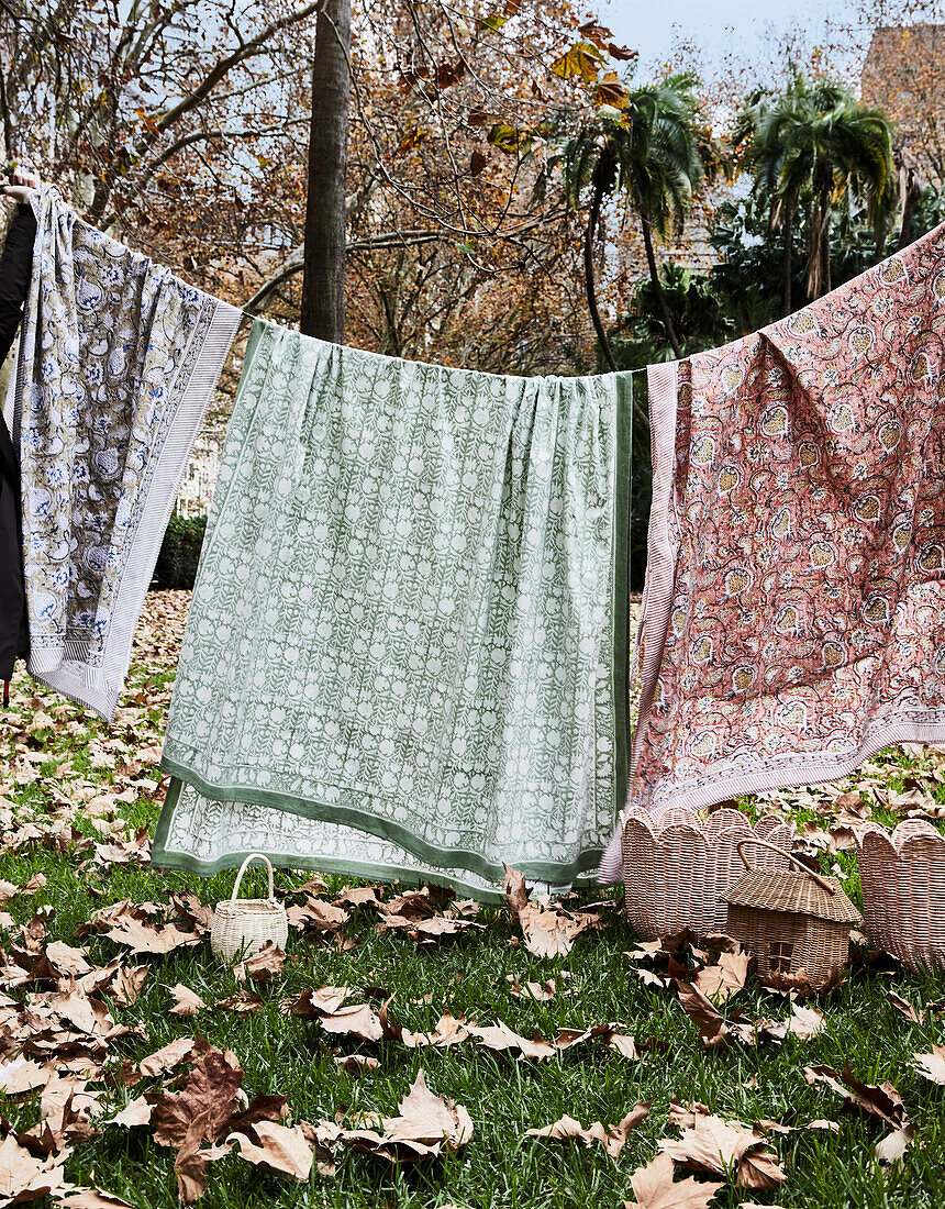 Clothesline with patterned cloths in autumn garden