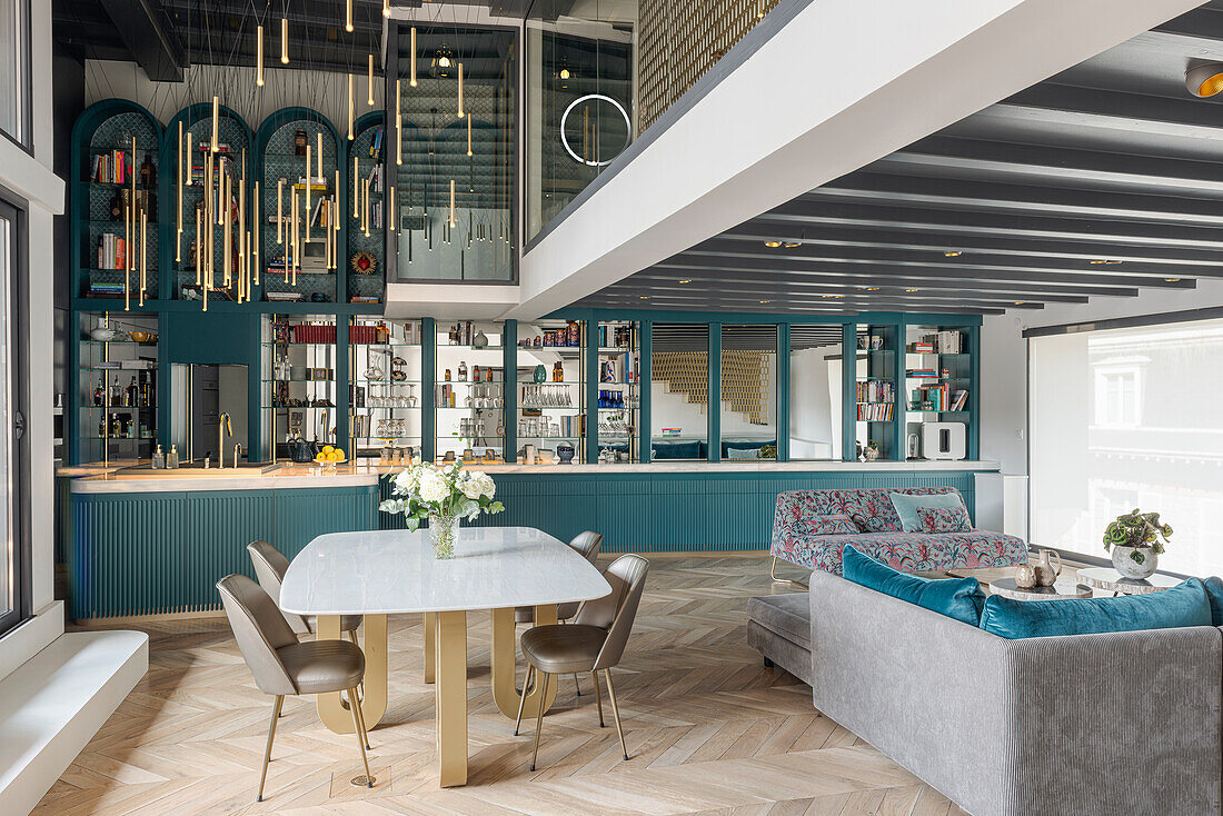 Open-plan living area with marble table and blue accents