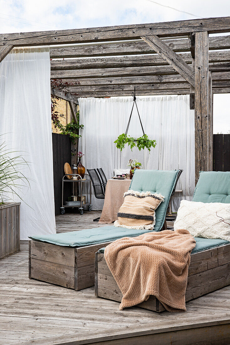 Terrace lounge with deckchairs and wooden pergola