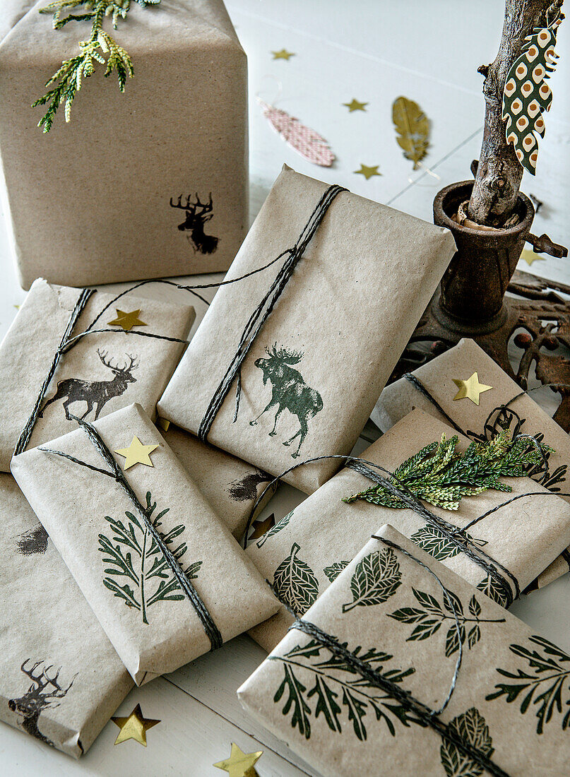 Gifts wrapped in brown paper with animal and plant motifs