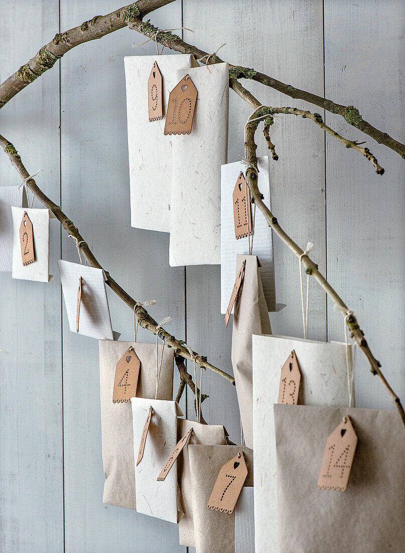 DIY advent calendar made from paper bags on branches