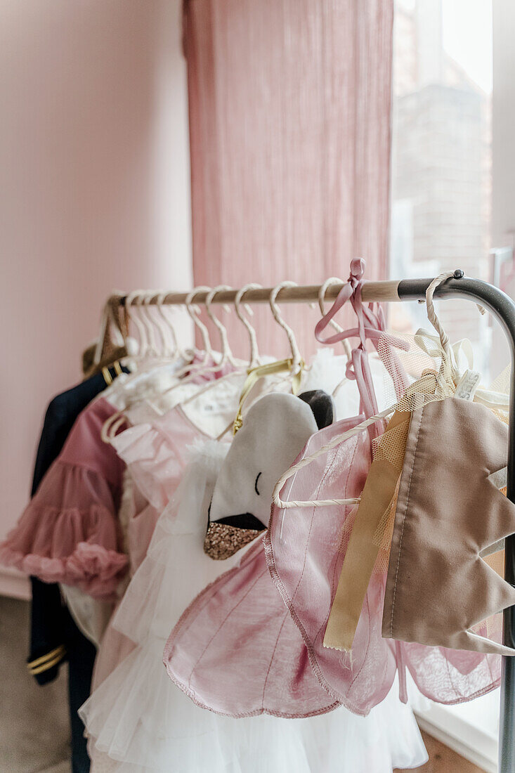 Clothes and costumes on a clothes rack in a children's room