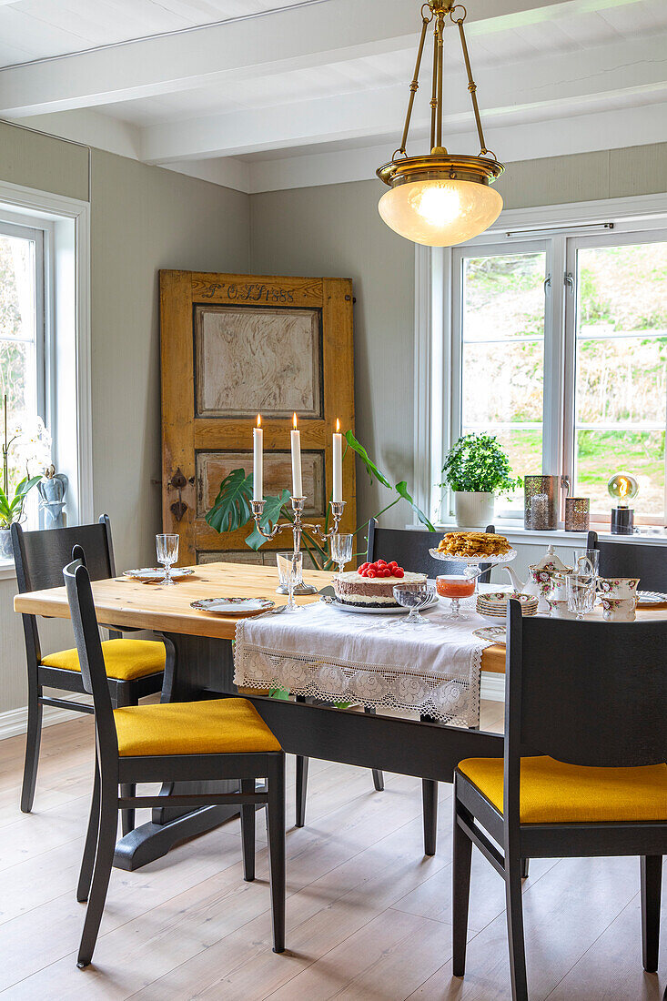 Set table in the dining room with antique door as decoration, country house style