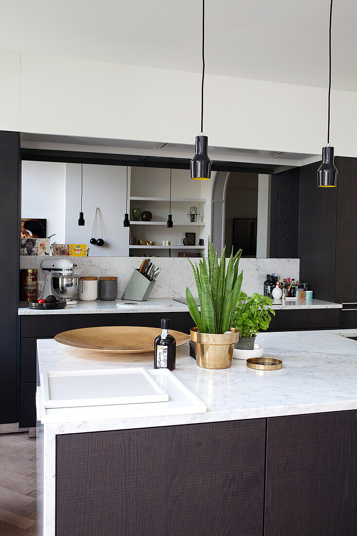 Modern kitchen with marble worktop and pendant lights