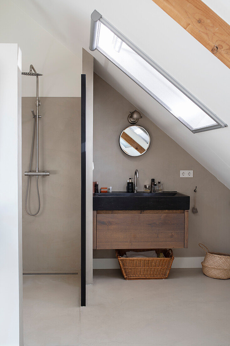 Bathroom with sloping roof and modern rain shower