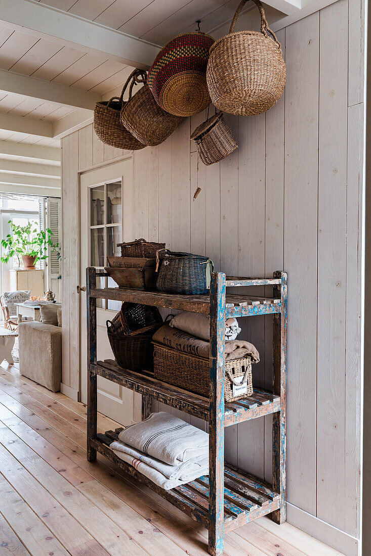 Old shelf and baskets in the hallway, country house style