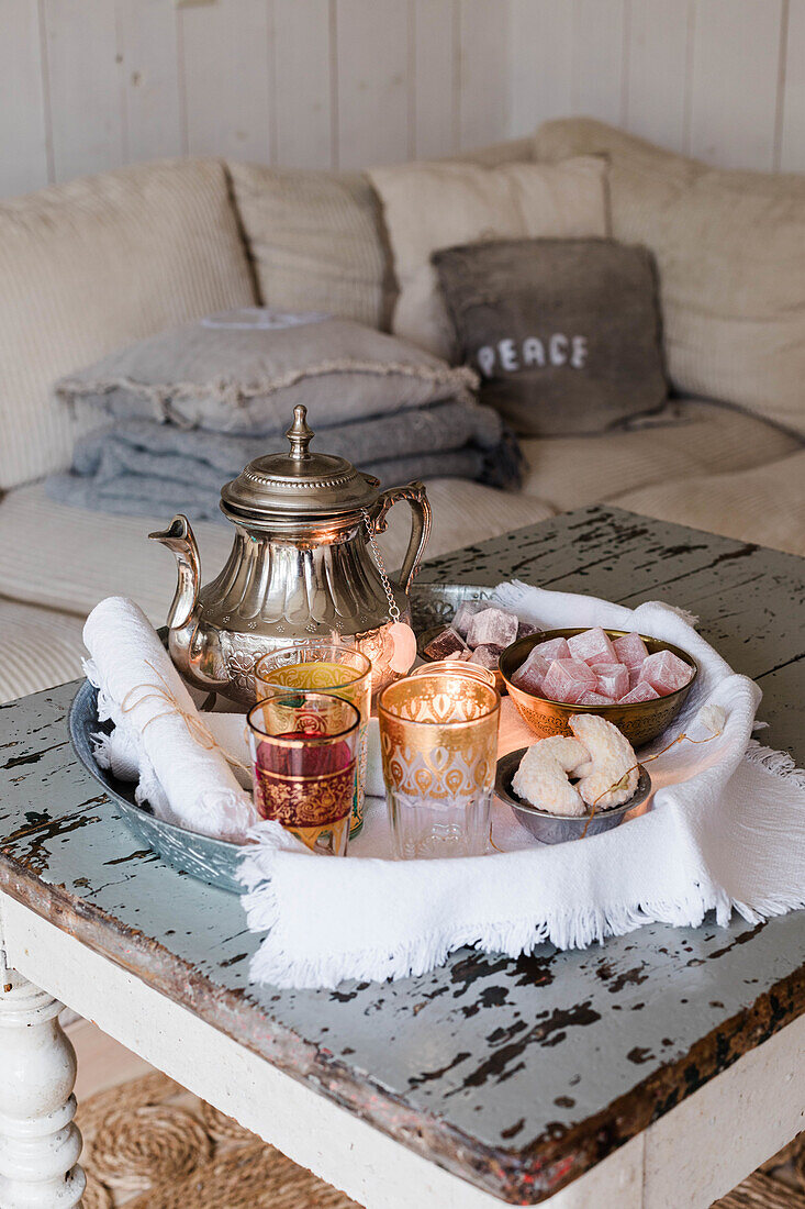 Serving tray with teapot, tea glasses and sweets in oriental style