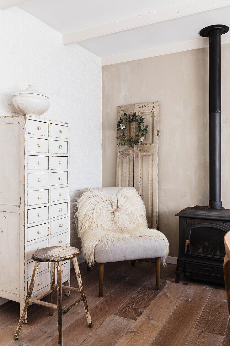 Rustic living room with vintage armchair and wood-burning stove