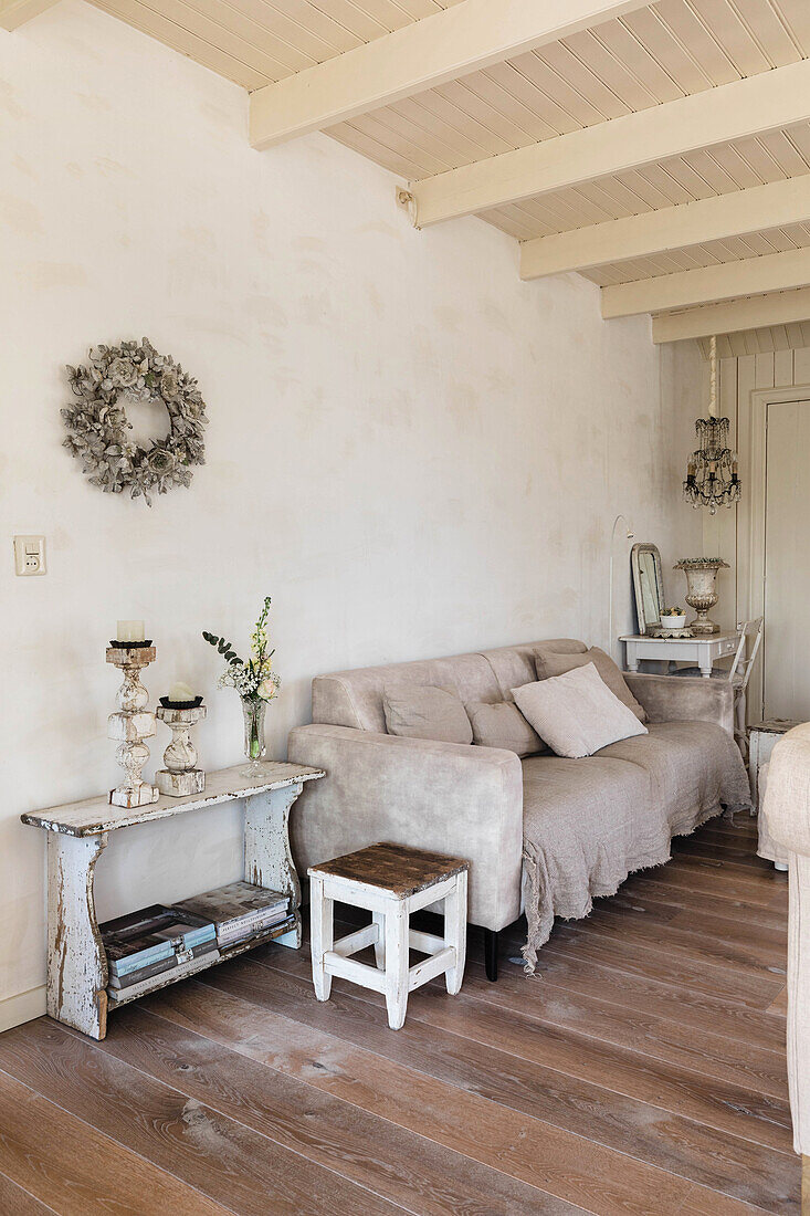 Living room with rustic wooden furniture and cream-colored sofa