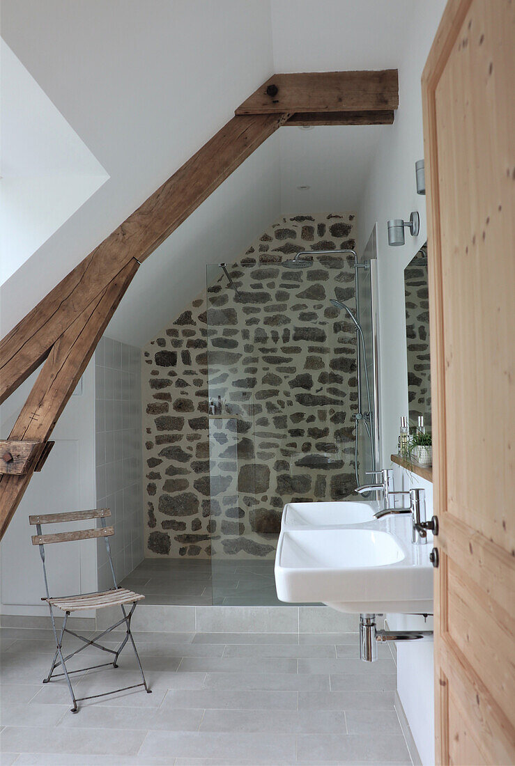 Bathroom with exposed half-timbering and natural stone wall in the shower