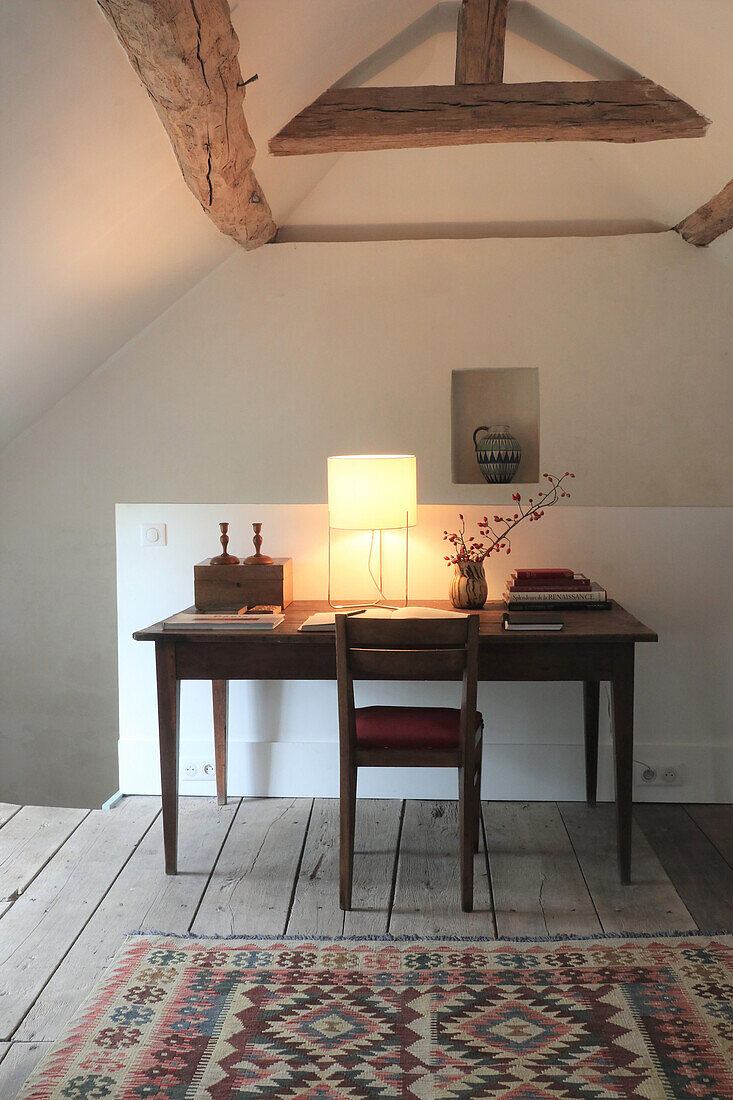 Rustic study with wooden furniture and oriental carpet