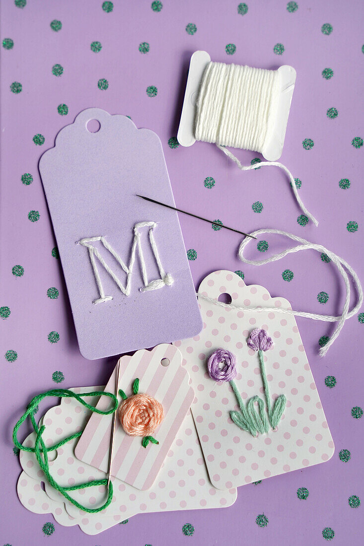 Embroidered gift tags on a dotted base