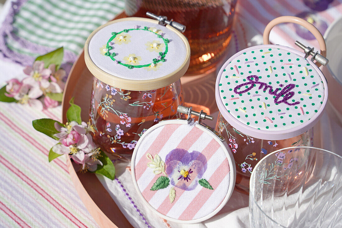 Homemade drink lids with floral print and embroidery