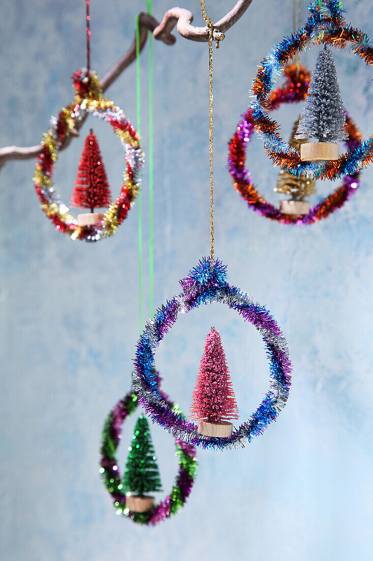 Homemade Christmas ornaments made from colorful, glittering chenille wire and decorative bottle trees