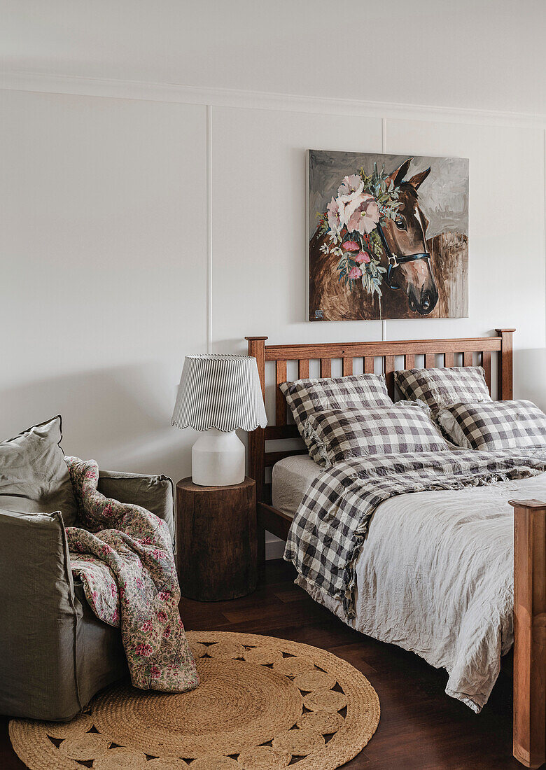 Bedroom with checkered bed linen and horse picture on the wall