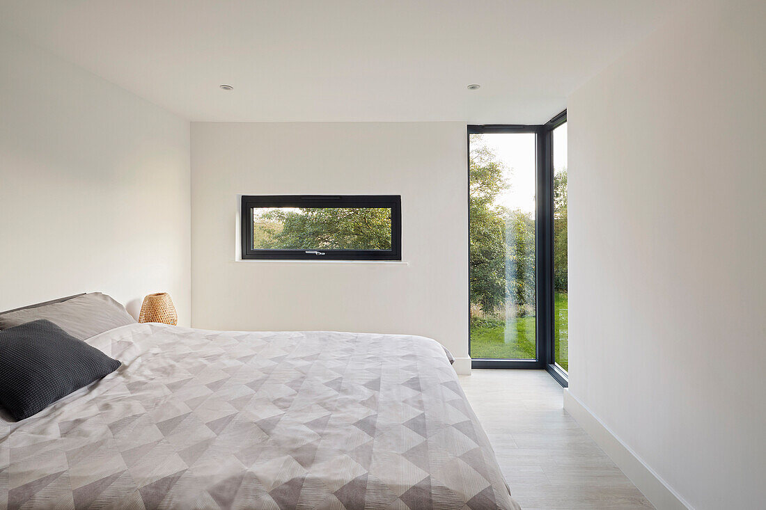 Bedroom in neutral colours with double bed and view of the garden