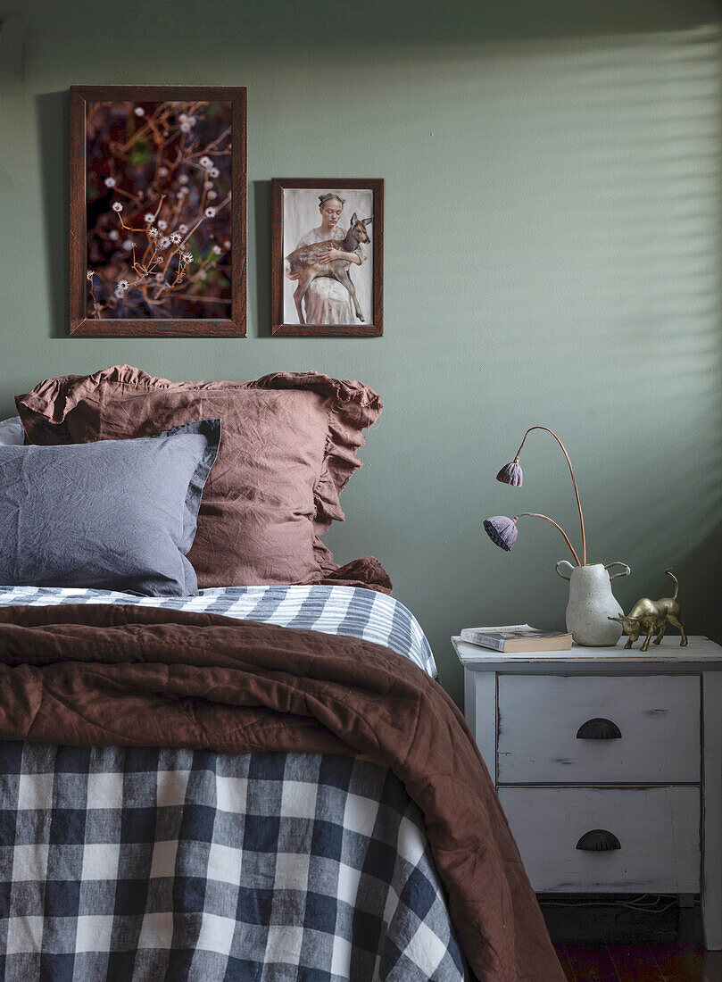 Bedroom with chequered duvet cover and green walls