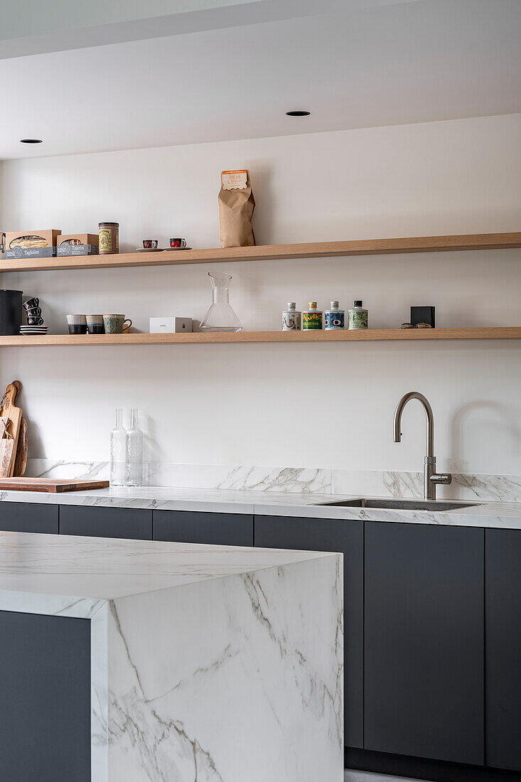 Modern kitchen with black cabinets and open wooden shelves