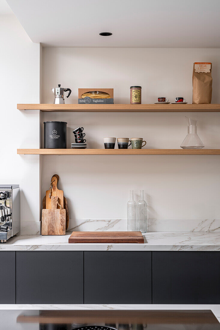 Modern kitchen with black base units and open wooden shelving