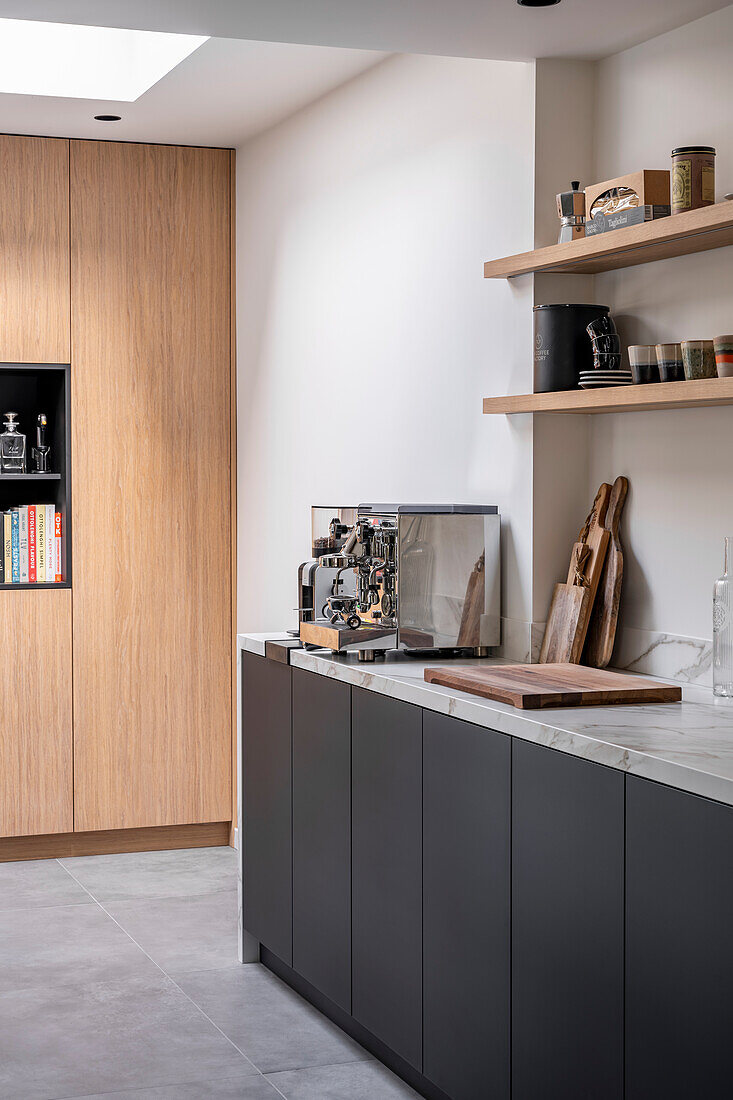 Customised kitchen with black front and wooden elements