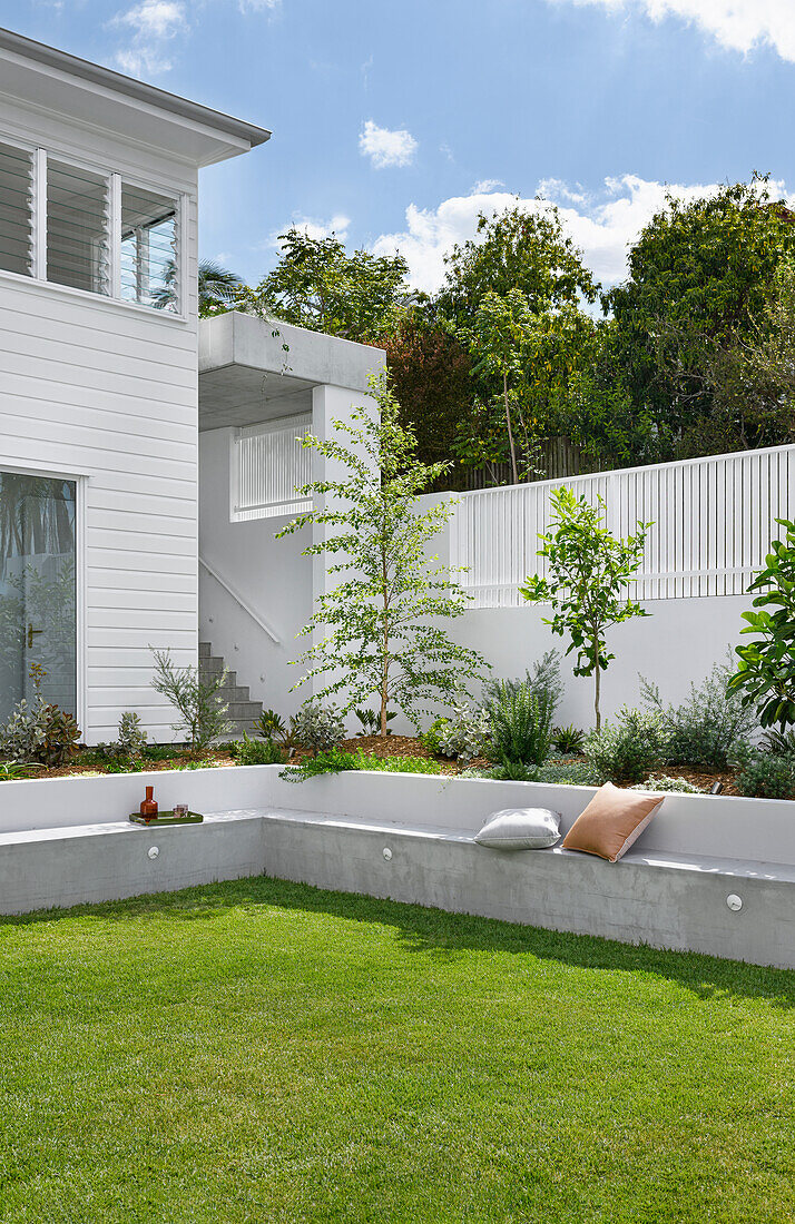 Garden with seating wall and fresh plants