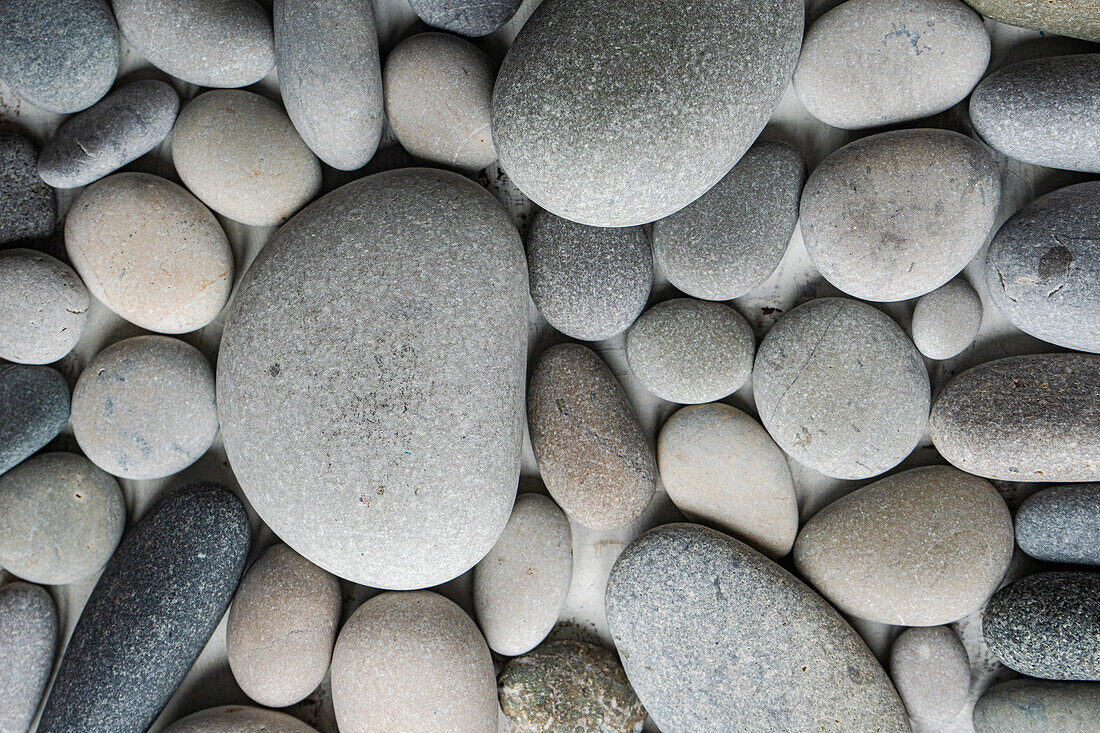 Various grey sea pebbles as a natural background texture