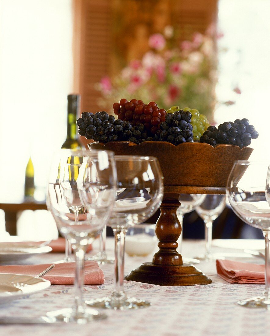 Bowl of grapes on laid table