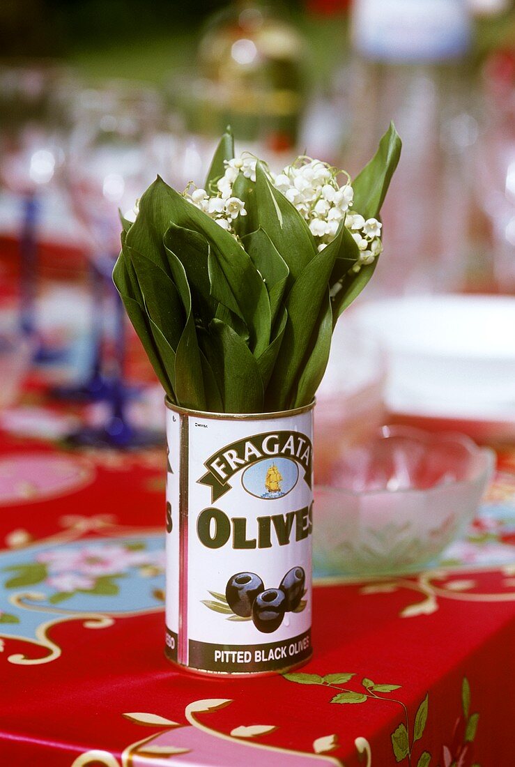 Lilies of the valley in olive tin