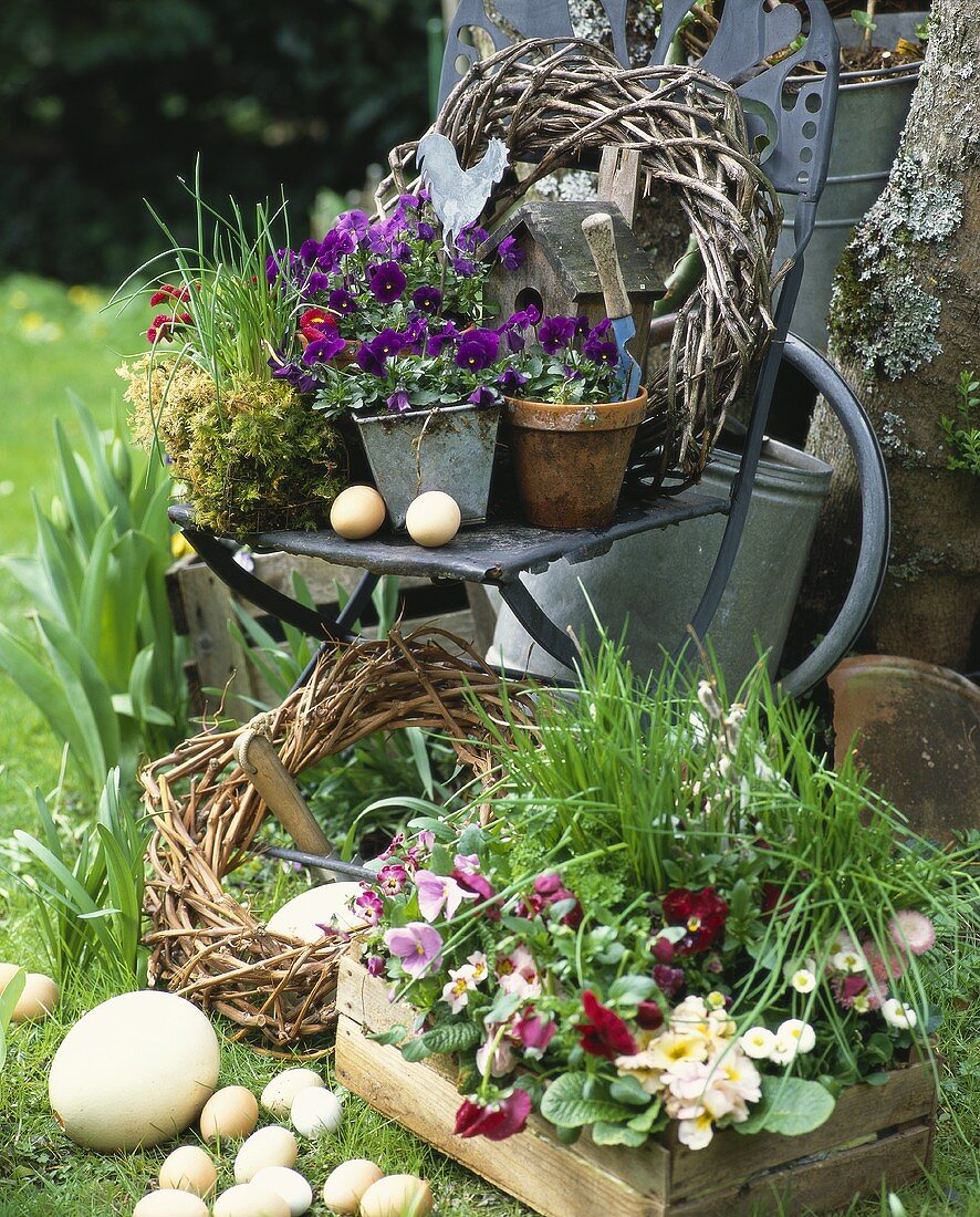 Easter decoration (flowerpots, wreaths, eggs) in garden