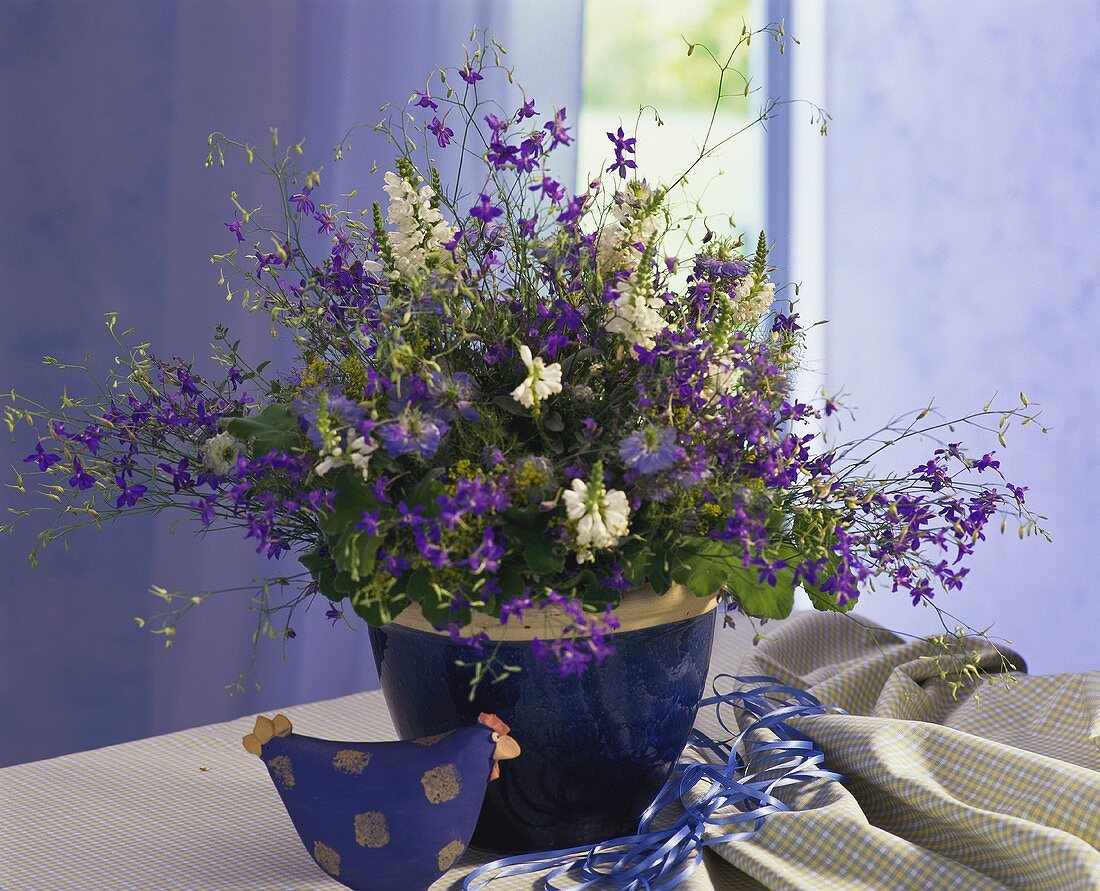 Colourful bouquet in blue ceramic pot
