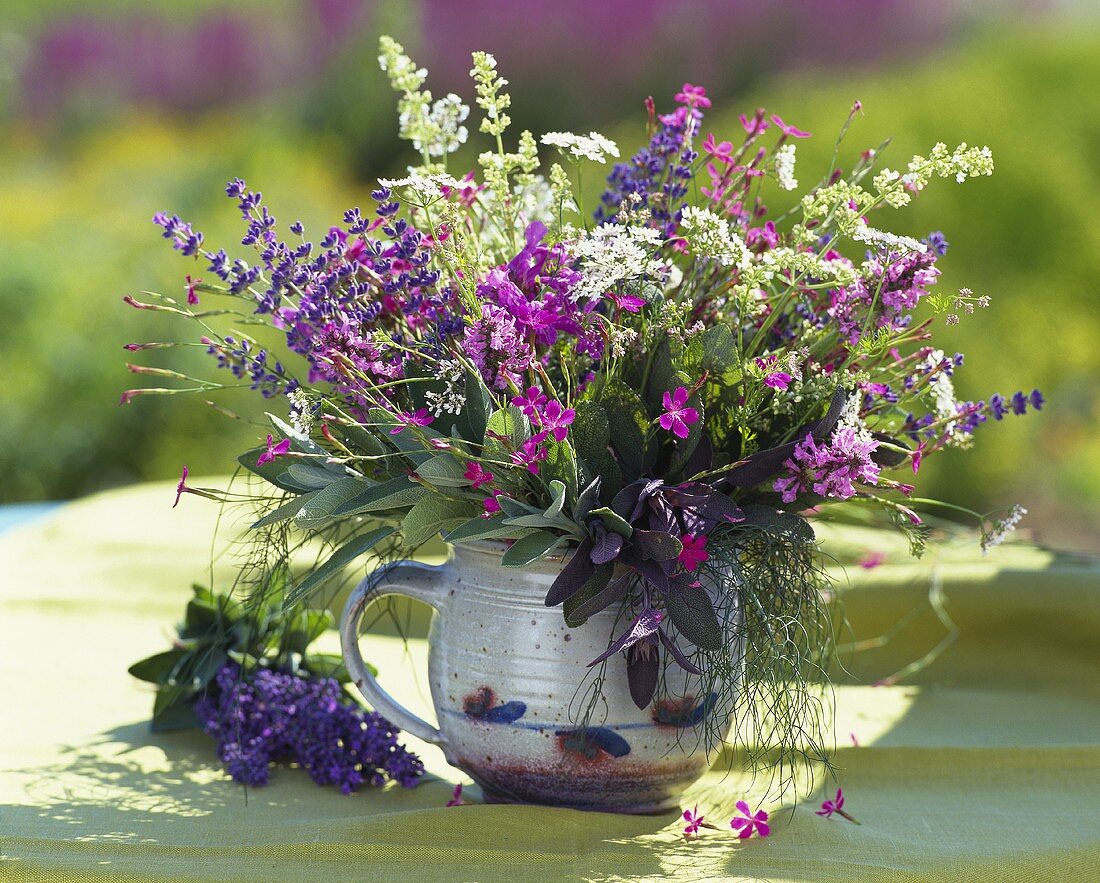 Fragrant bouquet of herbs in ceramic container
