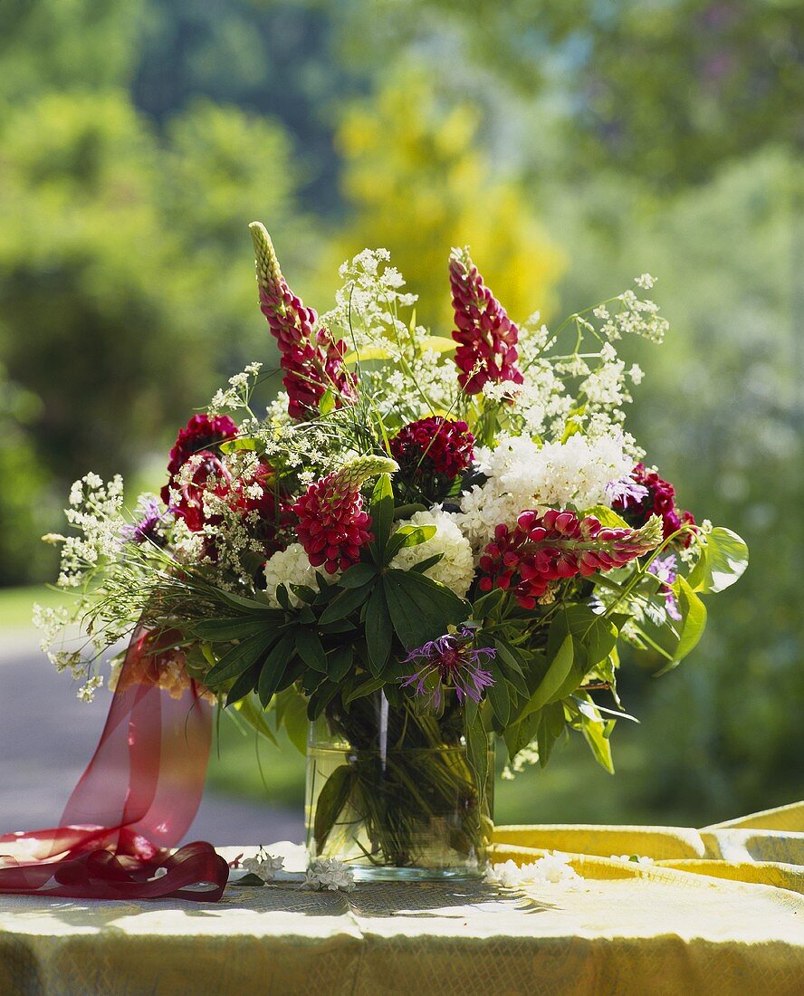 Red lupins with white hydrangeas