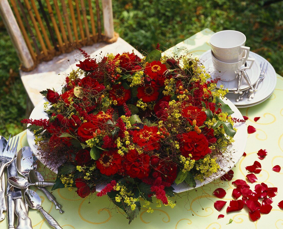 Arrangement of zinnias, roses, lady's mantle etc.