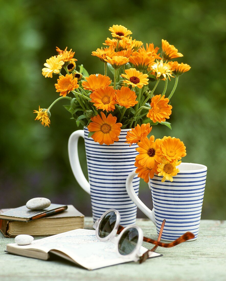 Bunch of marigolds in jug on garden table