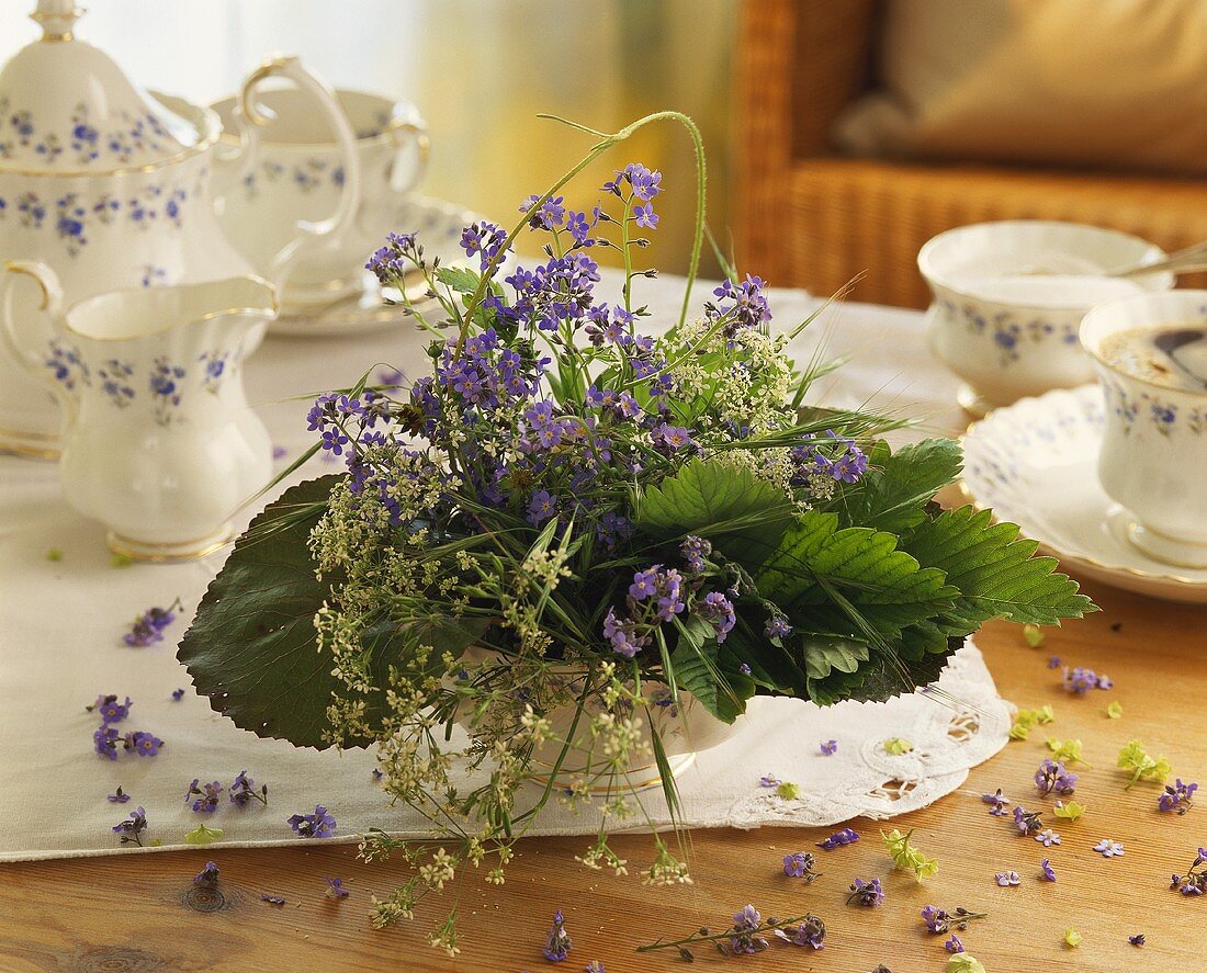 Spring arrangement of forget-me-nots on coffee table