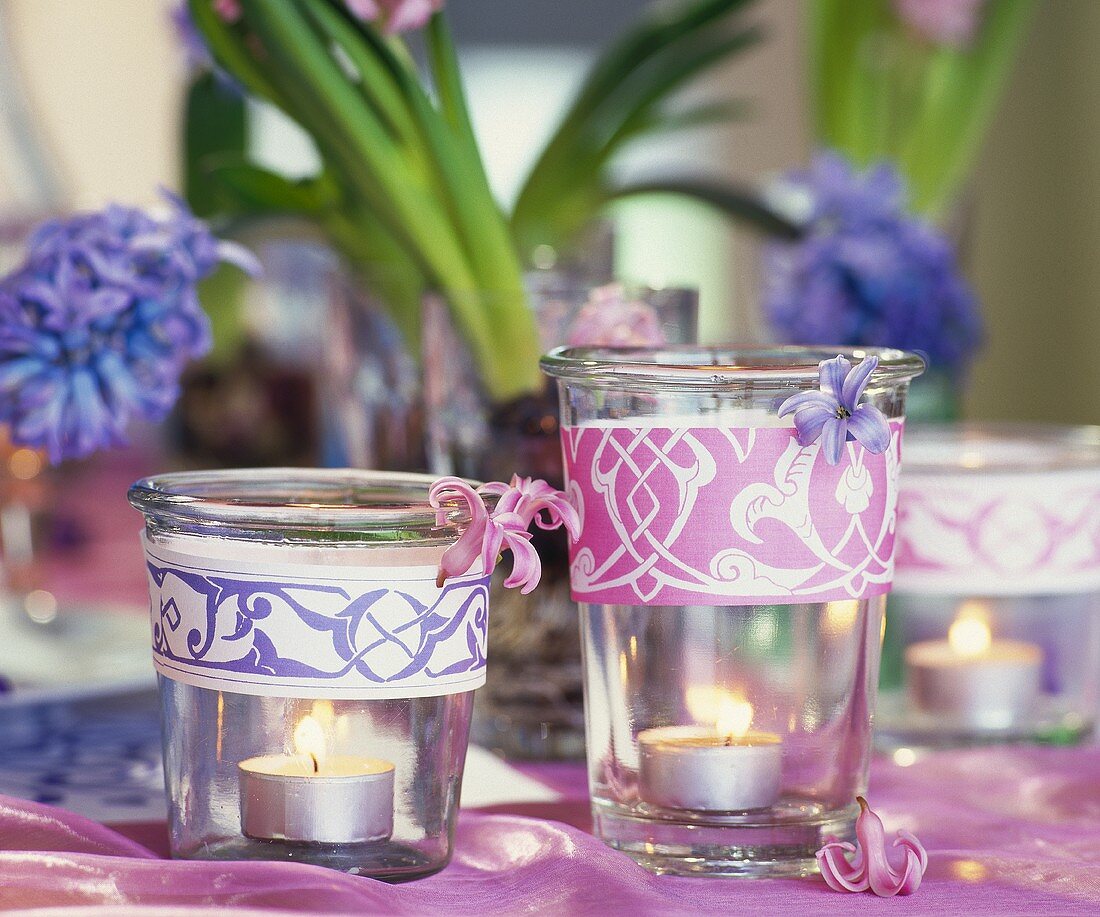 Table decoration of burning tea lights and hyacinths