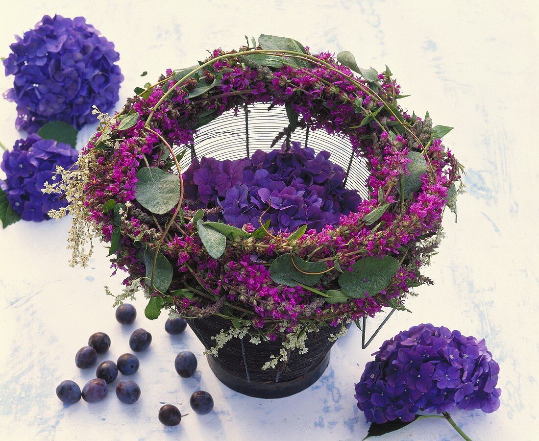 Wreath of purple loosestrife & Russian vine around hydrangea