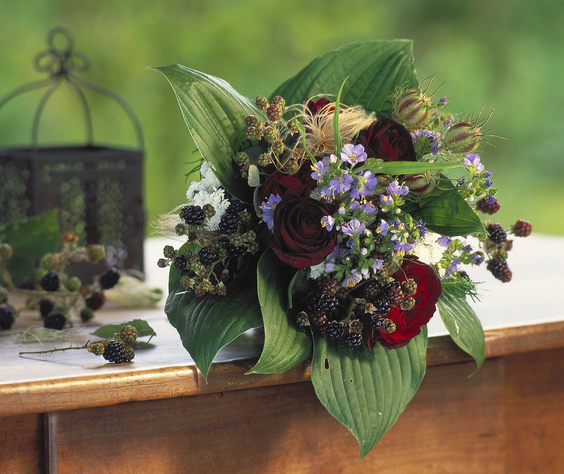 Bouquet of roses with hosta leaves, blackberries etc.