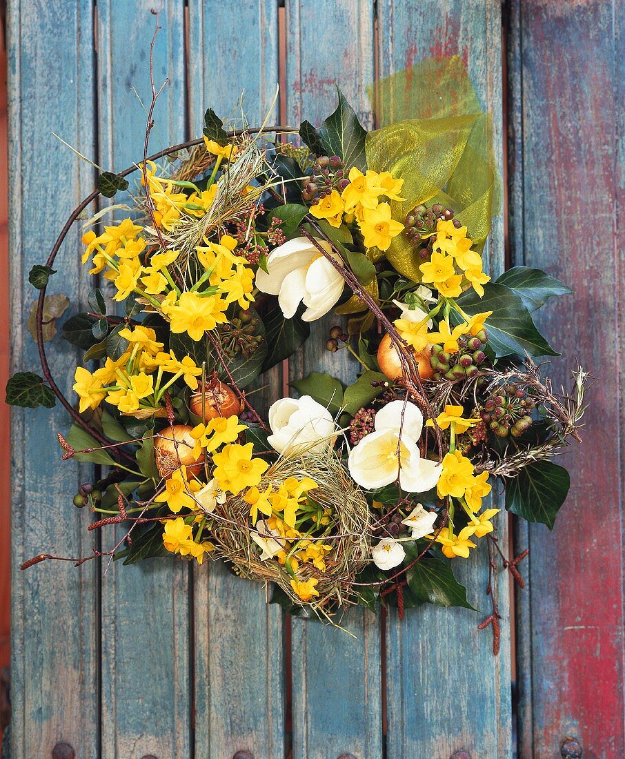 Wreath of spring flowers: narcissi, tulips, trailing ivy etc.