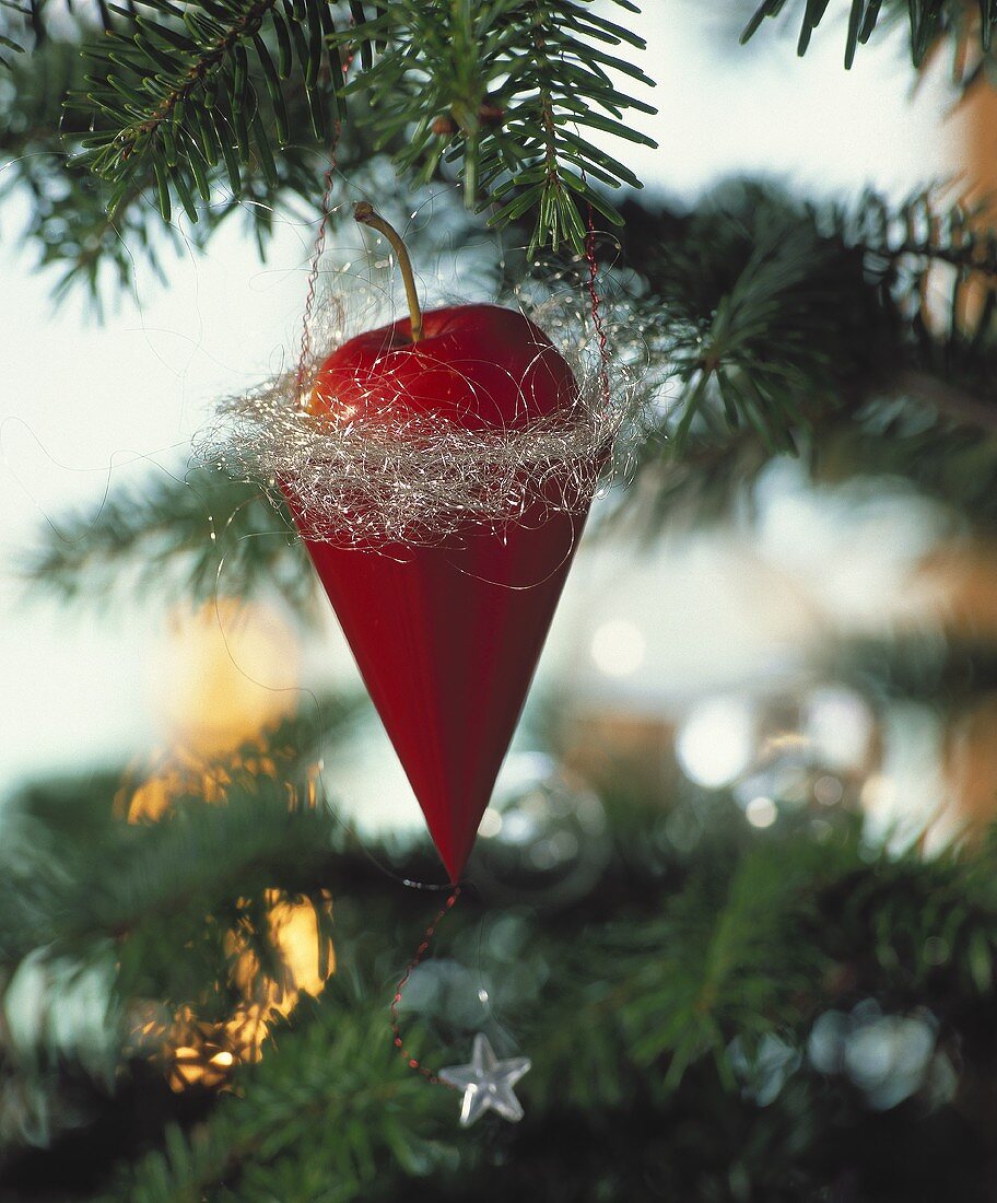 Red pointed bag of red apples on Christmas tree