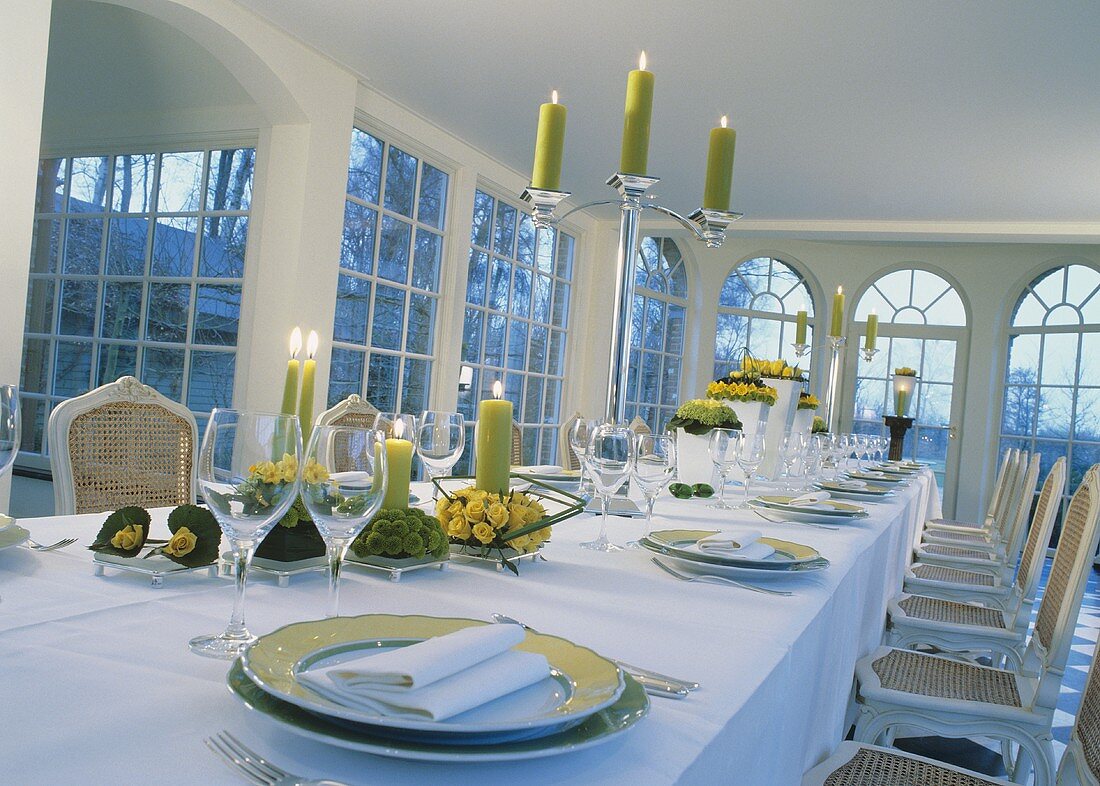 Wedding reception table with yellow flowers and lime green candles in traditional setting