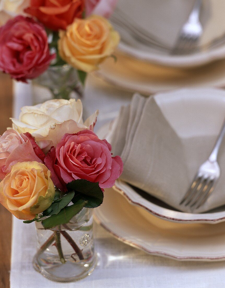 Small bouquets of roses on laid table