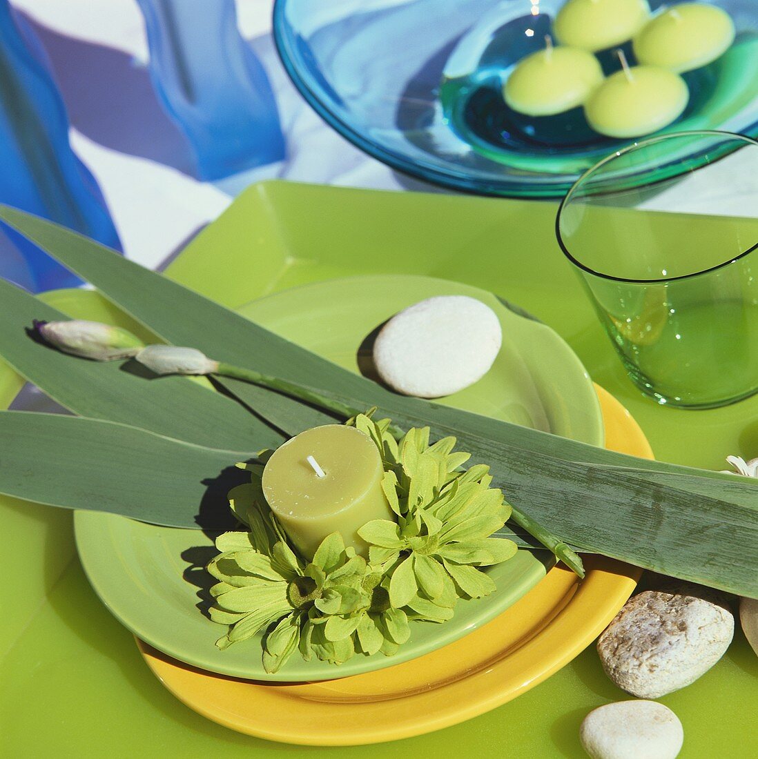 Place setting in spring colours with green candle