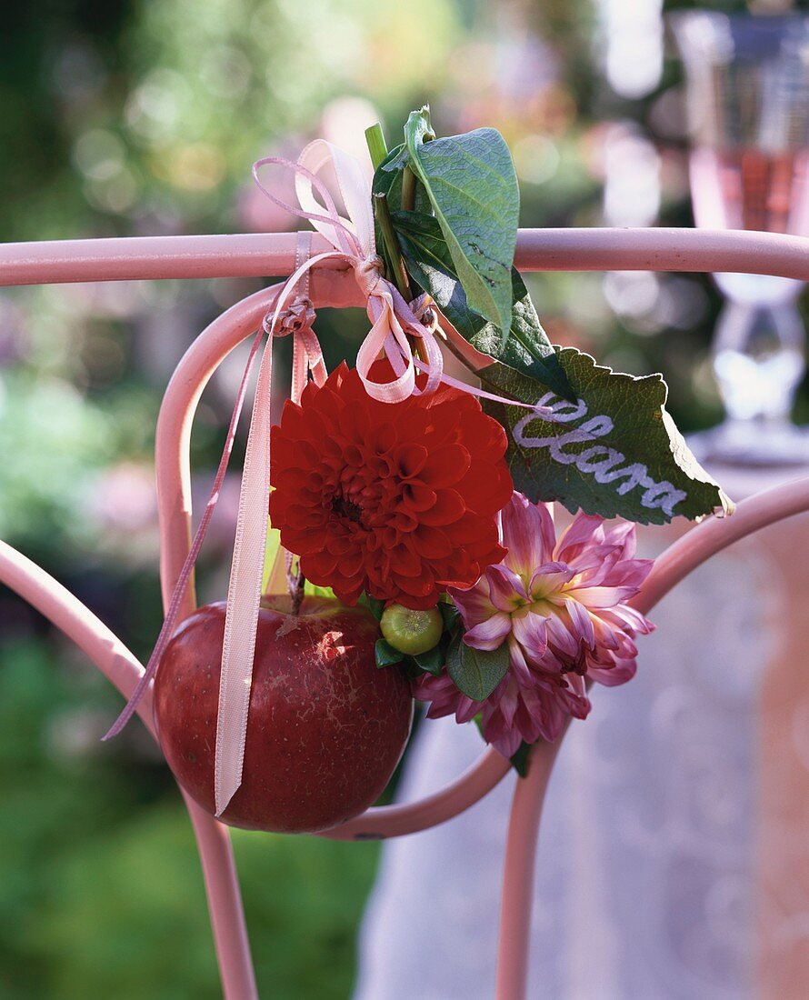Place card (leaf), dahlias & red apple tied to chair back