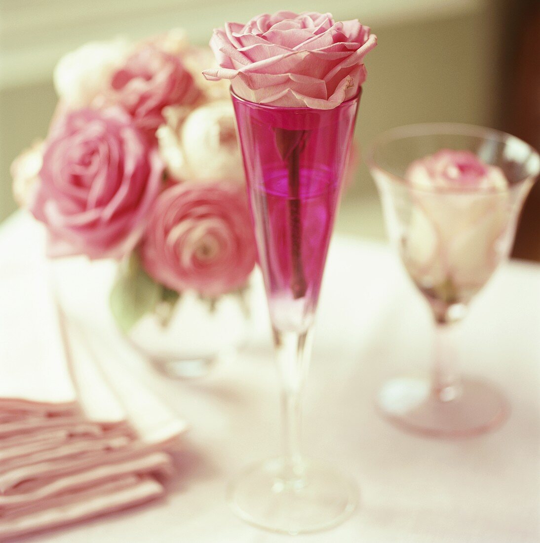 Romantic table decoration with rose in champagne glass