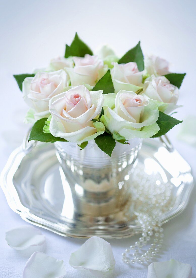 A bouquet of roses on a silver tray